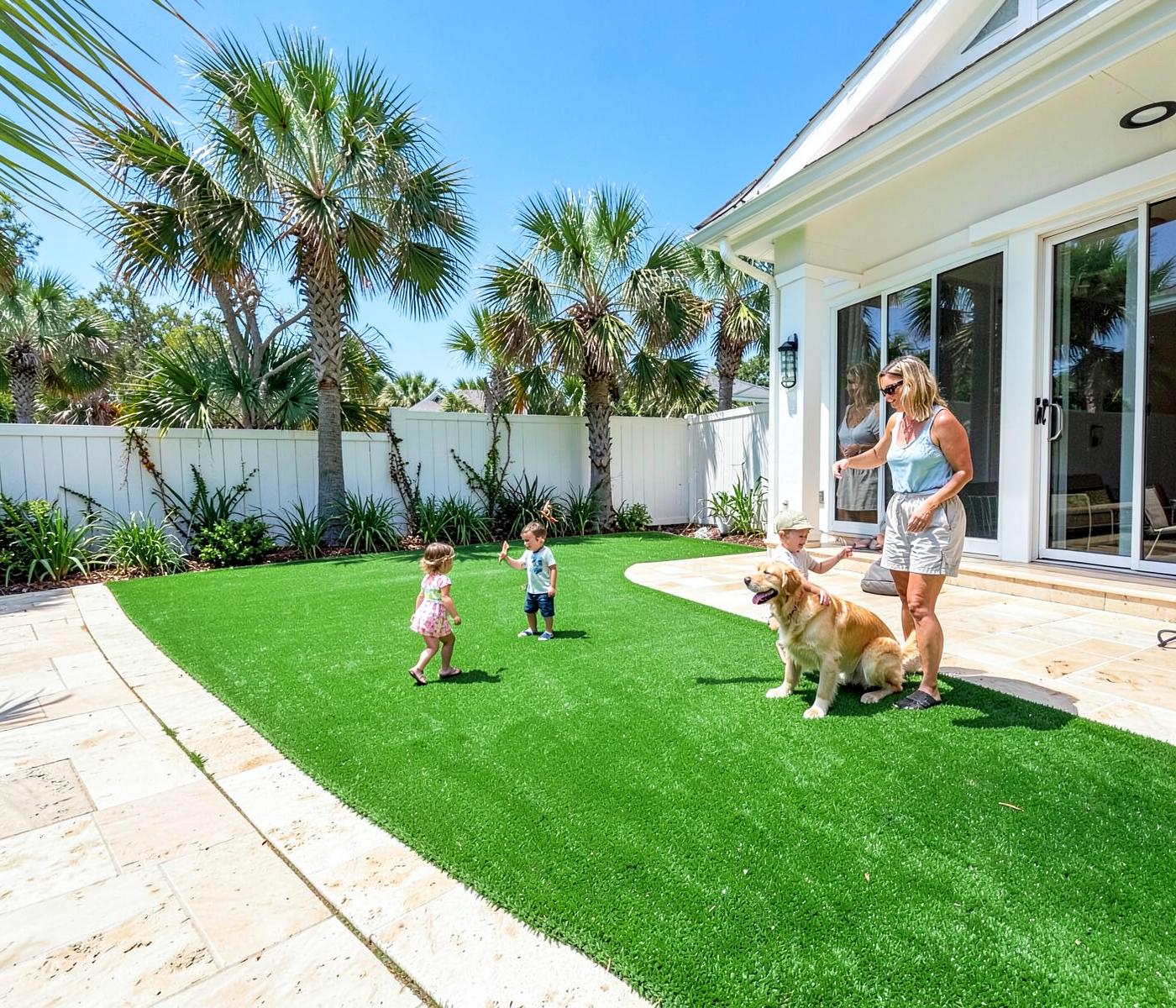 Family and golden retriever enjoying an artificial turf lawn