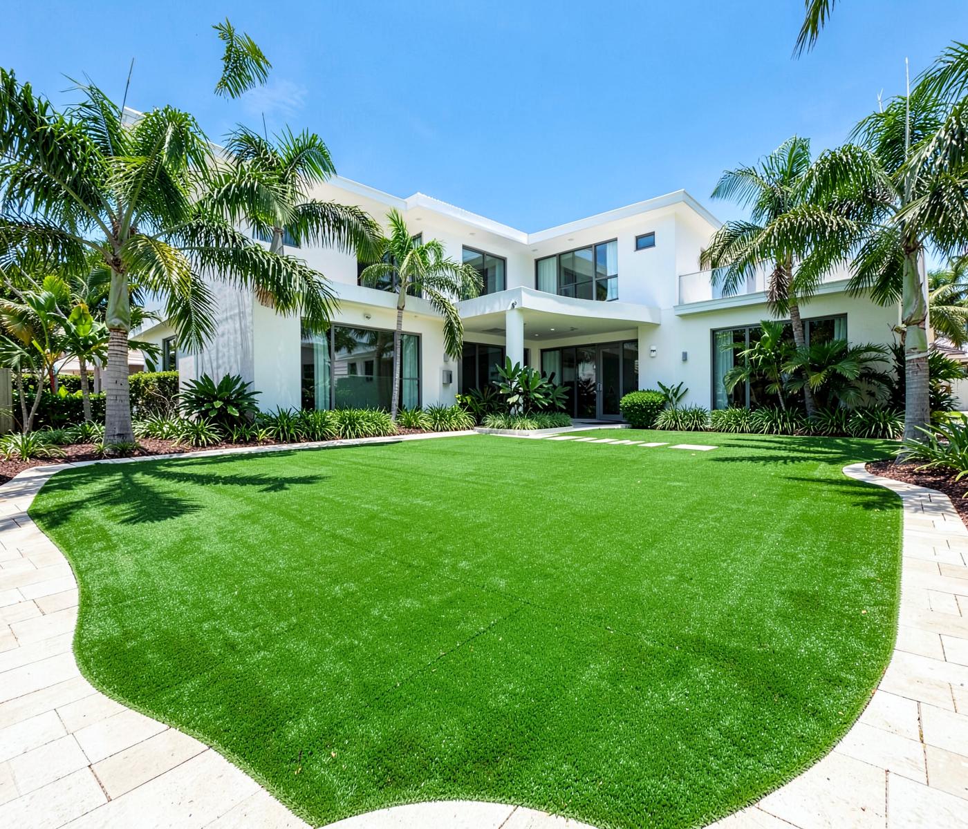 Lush artificial turf lawn with palms at a Florida home
